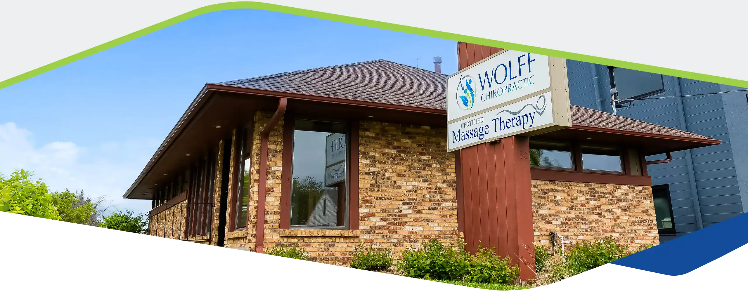 A brick building with a sign reading ‘Wolff Chiropractic – Certified Massage Therapy'