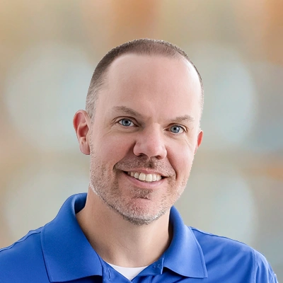 Dr. Duane Wolff wearing a blue collared shirt